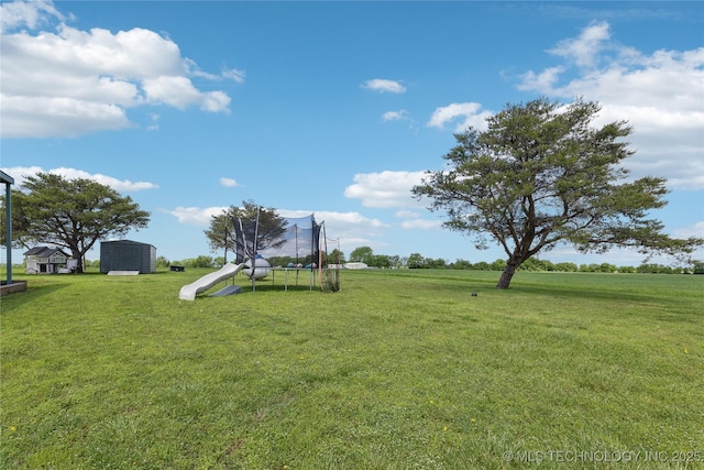7207 E 166th St, Collinsville, OK 74021 - view of green lawn with a trampoline