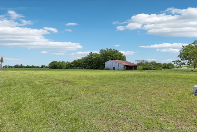 7207 E 166th St, Collinsville, OK 74021 - view of grassy yard with an outbuilding, a view of countryside, and an outdoor structure