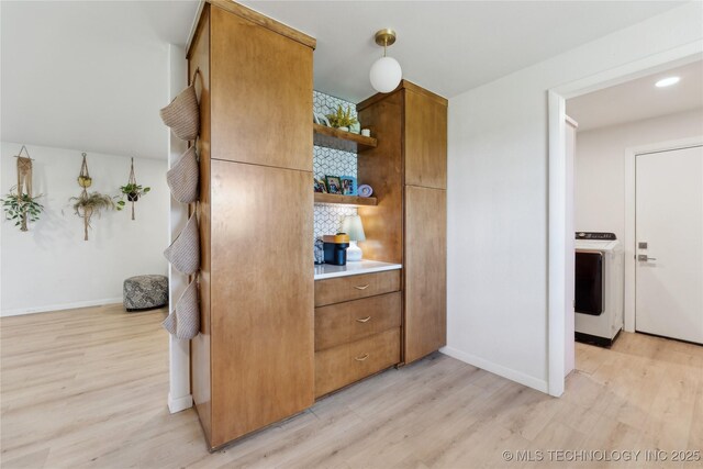 7207 E 166th St, Collinsville, OK 74021 - kitchen with washer / dryer, open shelves, light wood-style floors, and baseboards