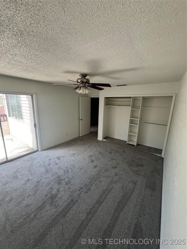 10911 E 11th Pl Unit 3B, Tulsa, OK 74128 - unfurnished bedroom featuring carpet, a ceiling fan, and a textured ceiling