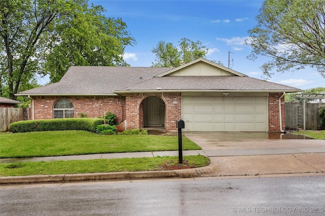 single story home featuring a front lawn, fence, brick siding, concrete driveway, and an attached garage