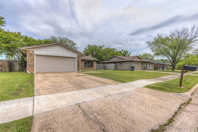 ranch-style house with a garage, fence, driveway, and a front lawn