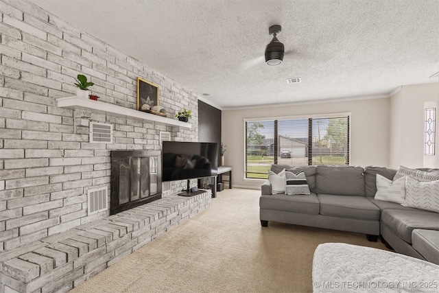 carpeted living area with visible vents, a textured ceiling, crown molding, and a fireplace