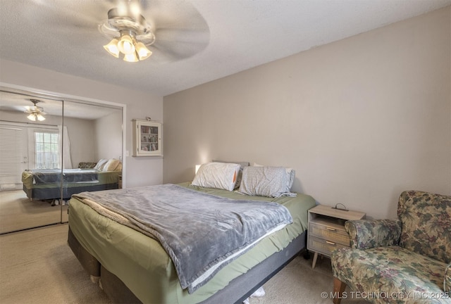 bedroom with ceiling fan, carpet, and a closet