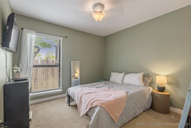 bedroom with carpet flooring and baseboards