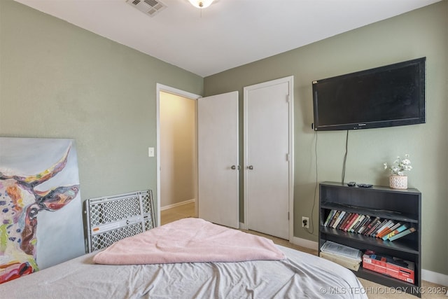 bedroom featuring carpet flooring, baseboards, and visible vents