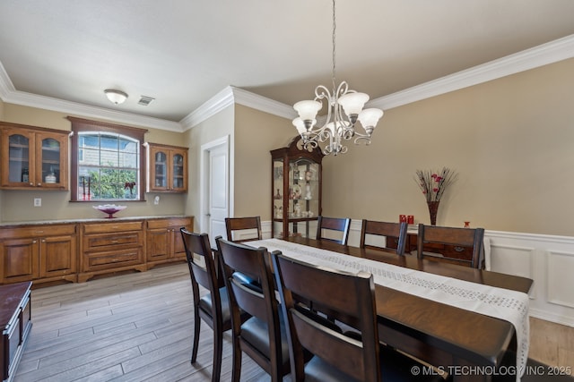7408 E Forest Ridge Blvd, Broken Arrow, OK 74014 - dining room featuring visible vents, a wainscoted wall, a notable chandelier, light wood-style floors, and ornamental molding