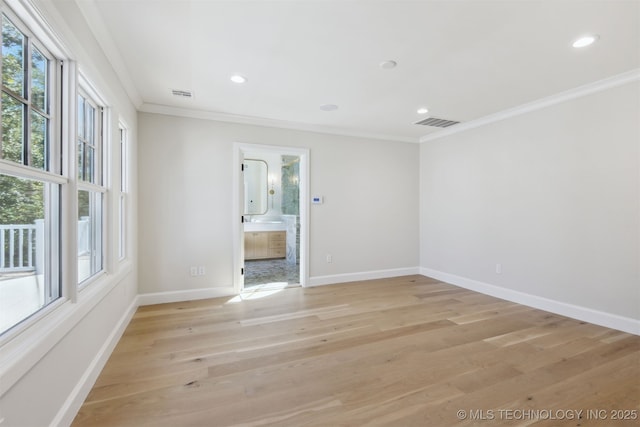 unfurnished room featuring crown molding, recessed lighting, baseboards, light wood-type flooring, and visible vents