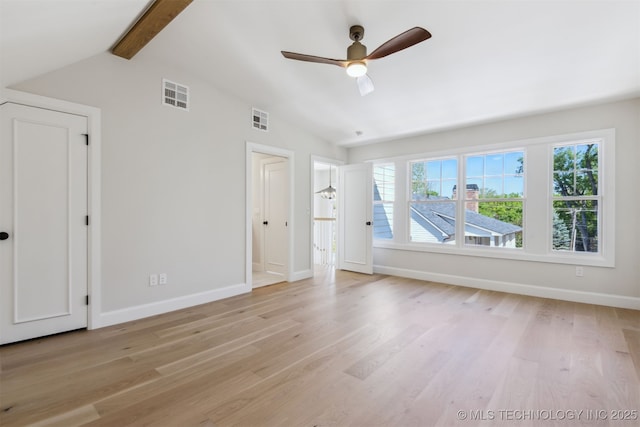 interior space featuring baseboards, vaulted ceiling with beams, and visible vents