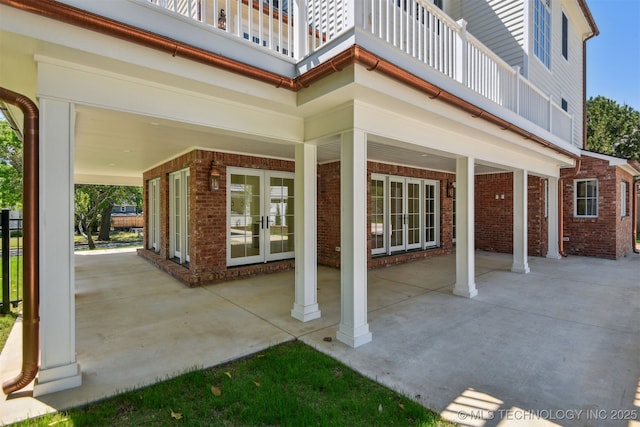 view of patio / terrace with french doors and a balcony