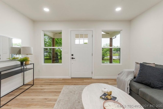 interior space featuring recessed lighting, baseboards, and light wood-type flooring