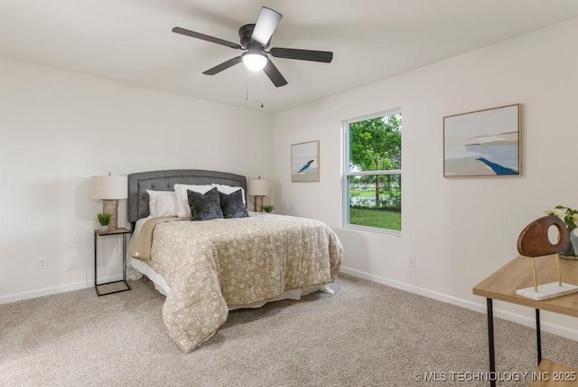 carpeted bedroom with baseboards and ceiling fan
