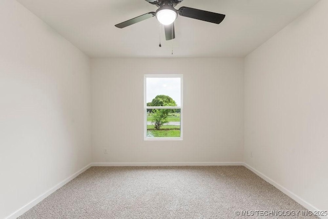 carpeted empty room with baseboards and ceiling fan
