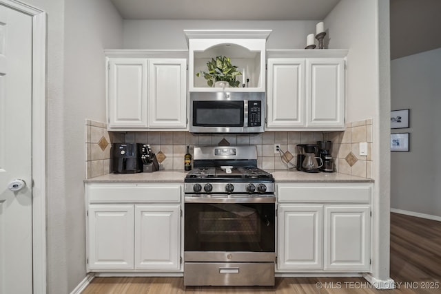 309 E 125th Ct S, Jenks, OK 74037 - kitchen with light wood-type flooring, decorative backsplash, white cabinetry, and appliances with stainless steel finishes