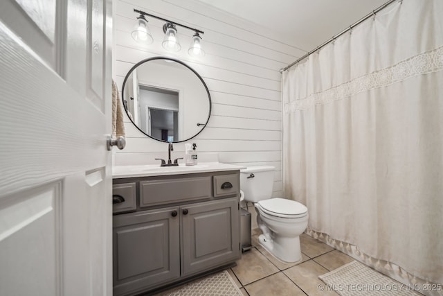 bathroom featuring wooden walls, vanity, toilet, tile patterned floors, and a shower with curtain