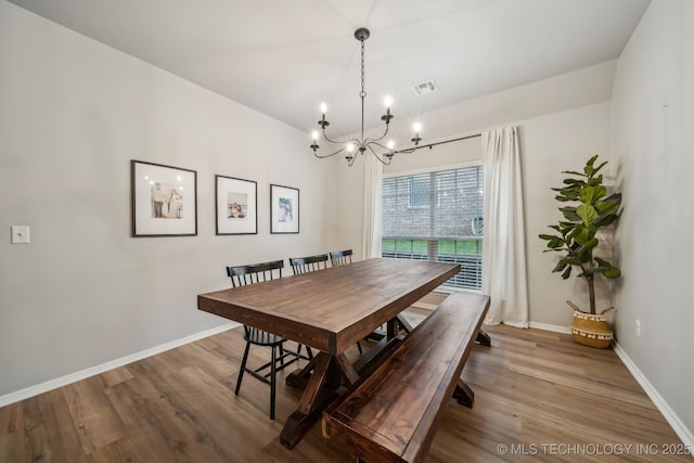 309 E 125th Ct S, Jenks, OK 74037 - dining area featuring an inviting chandelier, baseboards, wood finished floors, and visible vents