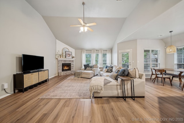 309 E 125th Ct S, Jenks, OK 74037 - living room with light wood finished floors, ceiling fan, a healthy amount of sunlight, and a fireplace