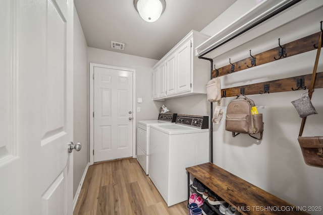 309 E 125th Ct S, Jenks, OK 74037 - washroom featuring independent washer and dryer, cabinet space, light wood-style flooring, baseboards, and visible vents