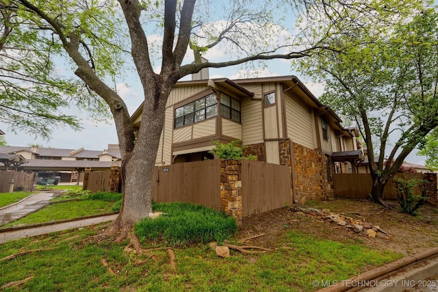 6371 S 80th Ave E Unit G, Tulsa, OK 74133 - view of side of home with stone siding
