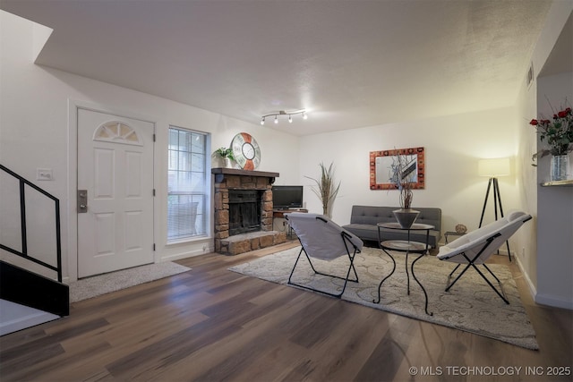 6371 S 80th Ave E Unit G, Tulsa, OK 74133 - living room featuring wood finished floors, a stone fireplace, and baseboards