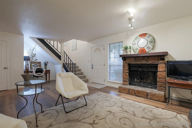 6371 S 80th Ave E Unit G, Tulsa, OK 74133 - living room with stairs, wood finished floors, and a fireplace