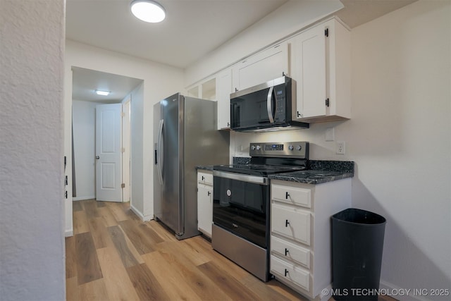kitchen featuring baseboards, light wood-style flooring, white cabinetry, and stainless steel appliances