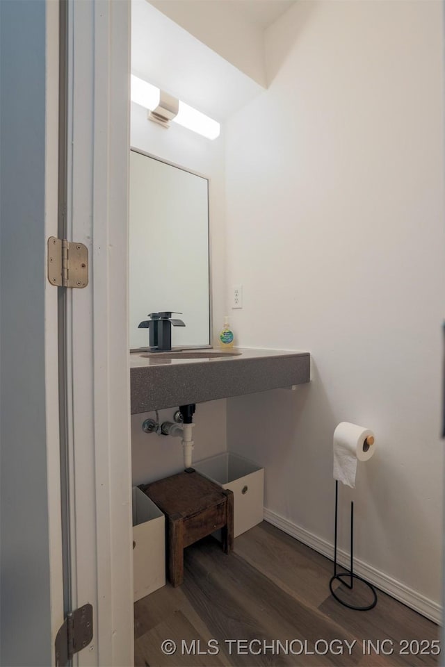 bathroom featuring baseboards and wood finished floors