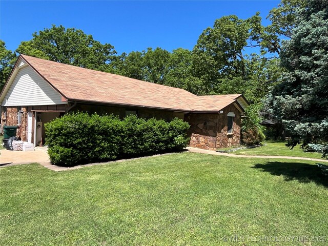 3316 Maple Dr, Sand Springs, OK 74063 - view of front of home with stone siding, a front yard, and an attached garage