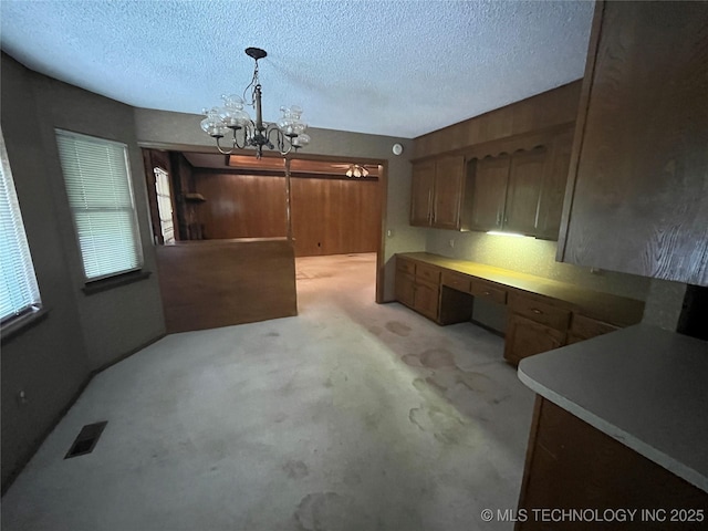 3316 Maple Dr, Sand Springs, OK 74063 - unfurnished dining area featuring a chandelier and a textured ceiling