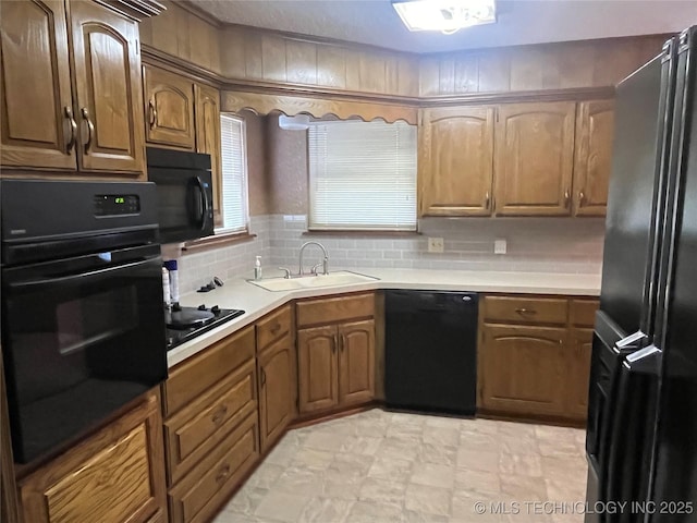 3316 Maple Dr, Sand Springs, OK 74063 - kitchen featuring black appliances, a sink, light countertops, and brown cabinets