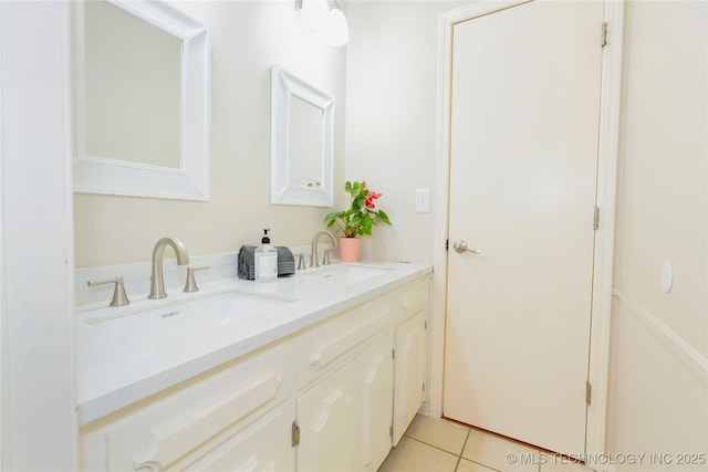 bathroom with double vanity, a sink, and tile patterned flooring