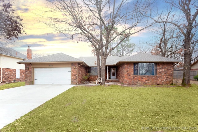 ranch-style house with a garage, brick siding, fence, a yard, and concrete driveway