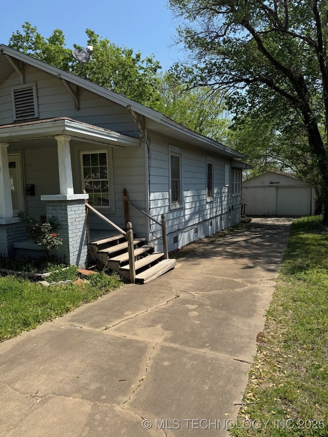 view of home's exterior featuring driveway and an outbuilding