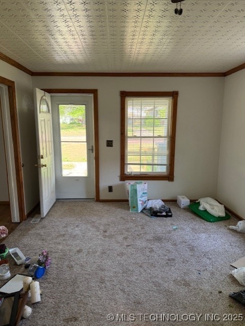 interior space featuring baseboards and ornamental molding