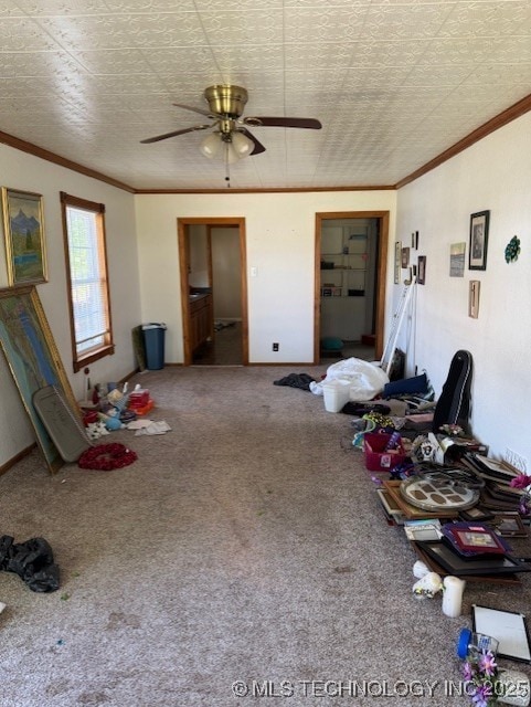 living room with crown molding, carpet flooring, and ceiling fan