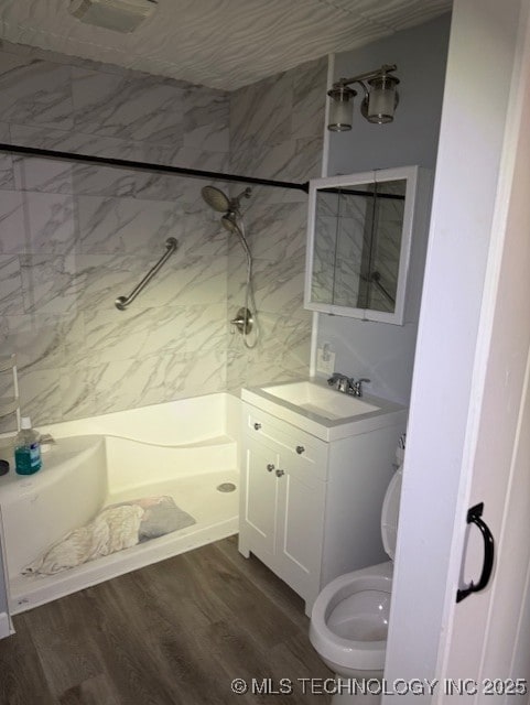 full bathroom featuring vanity, walk in shower, wood finished floors, and toilet