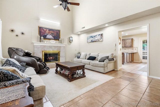 living area with ceiling fan, a fireplace, recessed lighting, light tile patterned floors, and visible vents