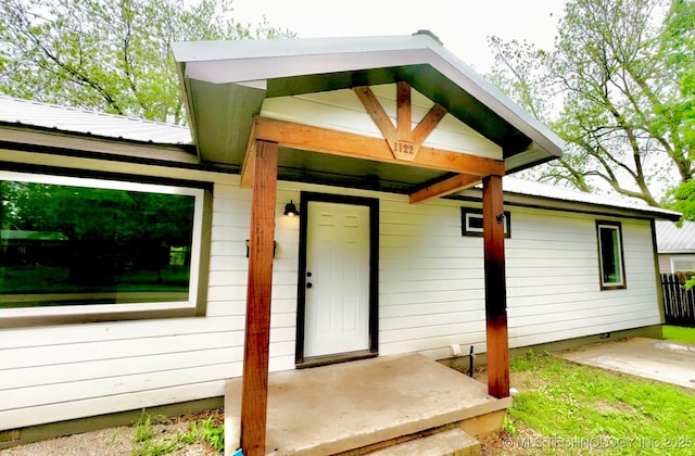 entrance to property featuring metal roof