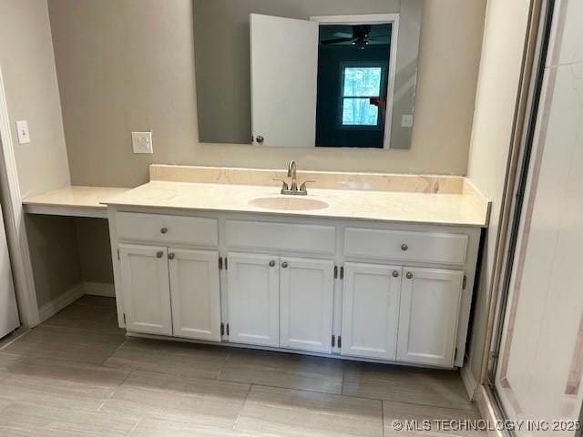 bathroom with baseboards and vanity