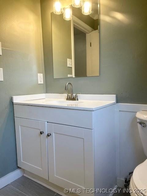 half bathroom with toilet and vanity