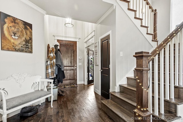 entrance foyer featuring crown molding, baseboards, stairs, and wood finished floors