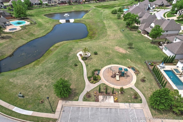 birds eye view of property featuring a water view and a residential view