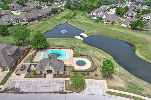 birds eye view of property featuring a water view and a residential view