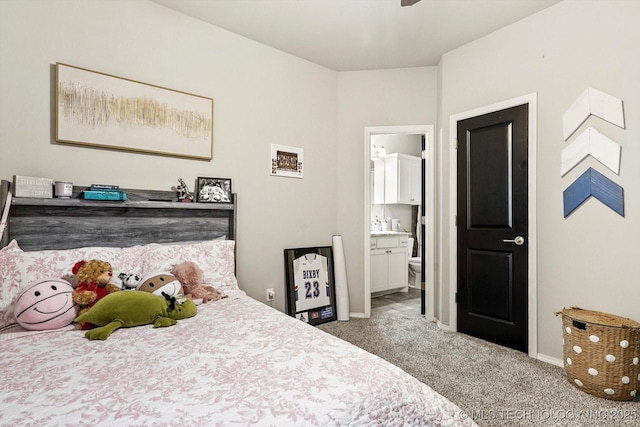 bedroom featuring carpet floors, baseboards, and ensuite bathroom