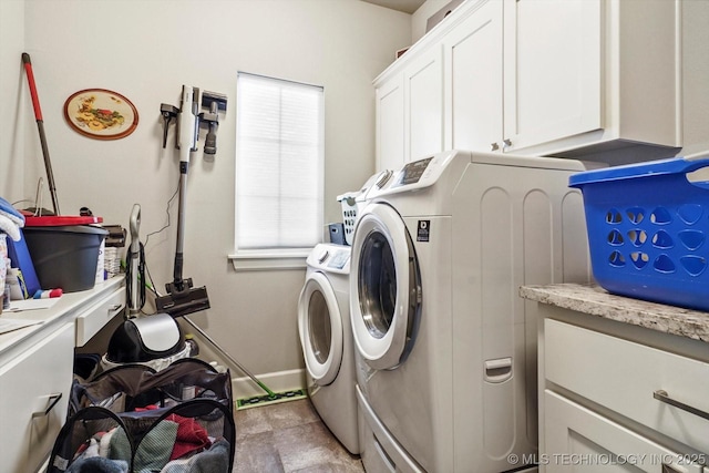 clothes washing area with cabinet space and independent washer and dryer