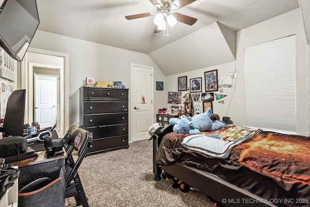 carpeted bedroom with a ceiling fan and vaulted ceiling
