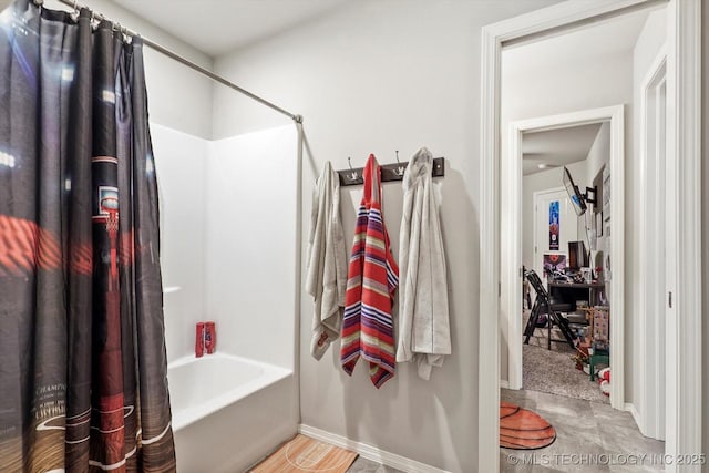 full bathroom featuring baseboards and shower / bath combo