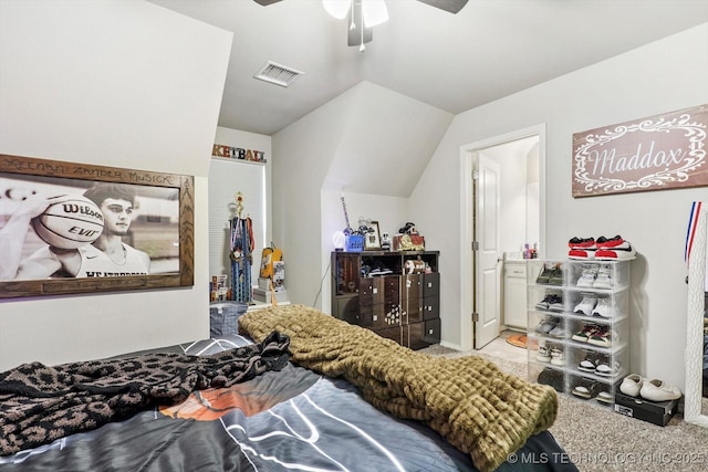 carpeted bedroom with a ceiling fan, vaulted ceiling, ensuite bath, and visible vents