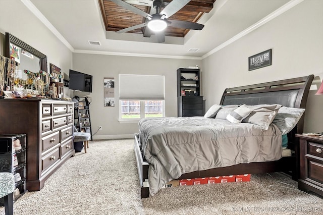 carpeted bedroom with visible vents, crown molding, baseboards, ceiling fan, and a tray ceiling