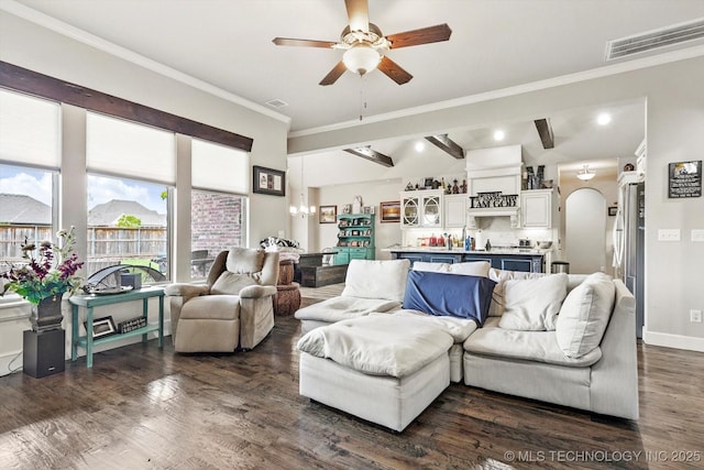 living area with arched walkways, ornamental molding, a ceiling fan, visible vents, and dark wood-style floors